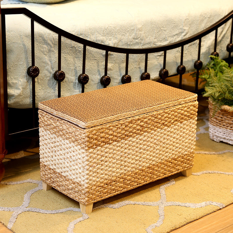 Rectangular hand-braided rattan storage stool with a removable lid – shown in a room setting